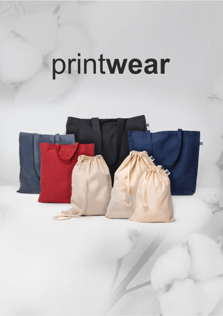 Assorted tote bags in blue, black, and red with beige drawstring pouches on a white surface; 'printwear' text appears above.